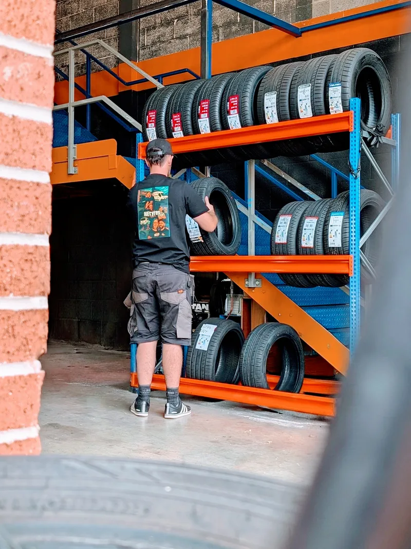 HEtyres team member selecting a tyre from stock at the depot