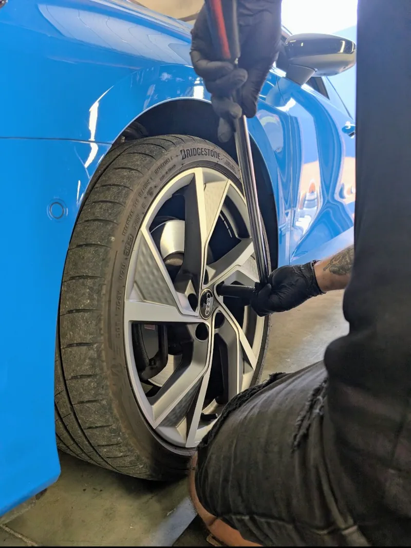 Fitting a new tyre to an Audi alloy wheel in the workshop